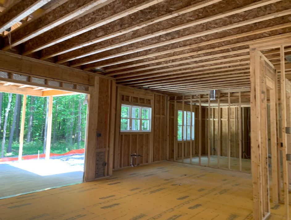 Residential construction framing prepared for coordinated electrical work